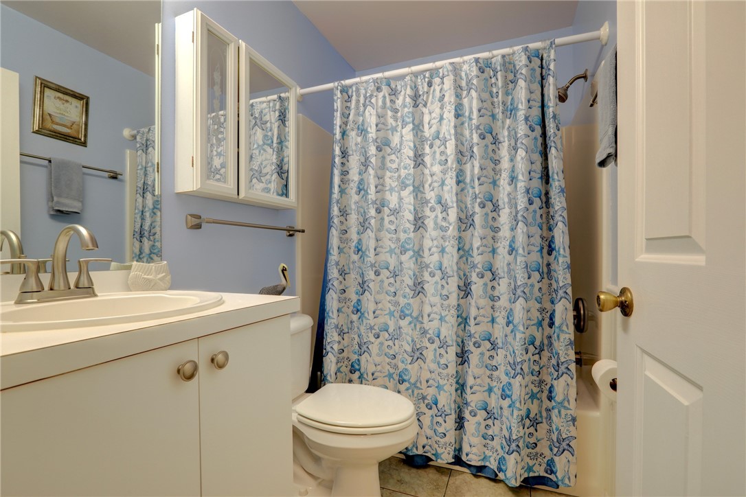9635 Riverside Drive, Unit 4 Sebastian, FL 32958 - Photo 20 of 34 a bathroom with a sink toilet and shower