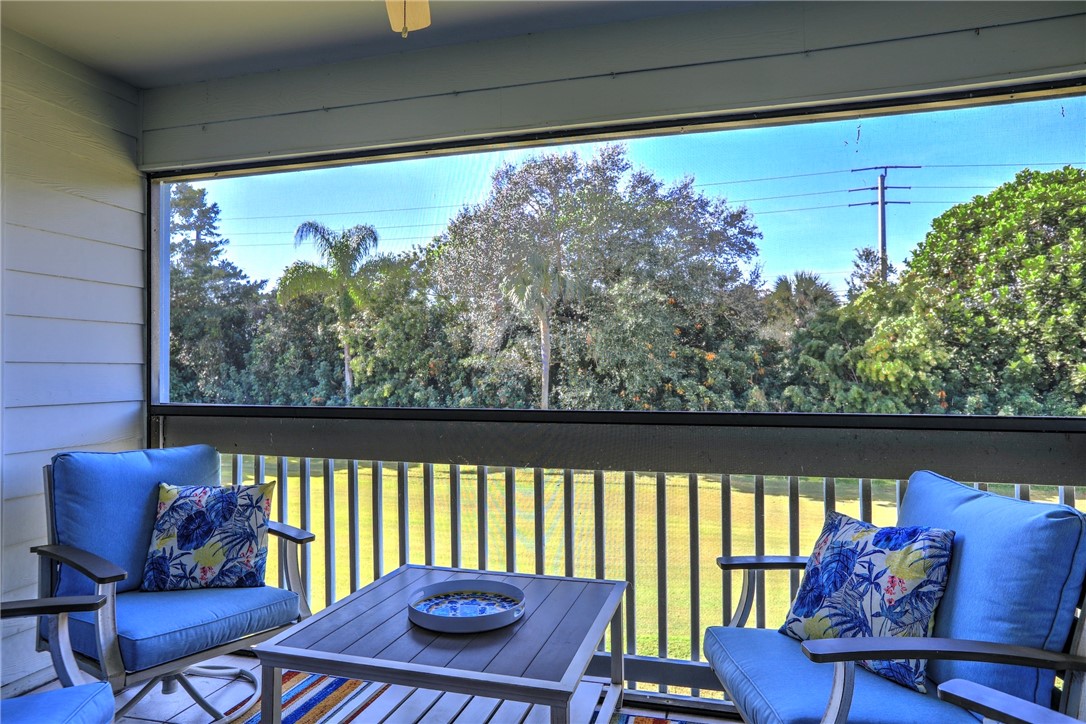 9635 Riverside Drive, Unit 4 Sebastian, FL 32958 - Photo 2 of 34 a balcony view with a garden and furniture