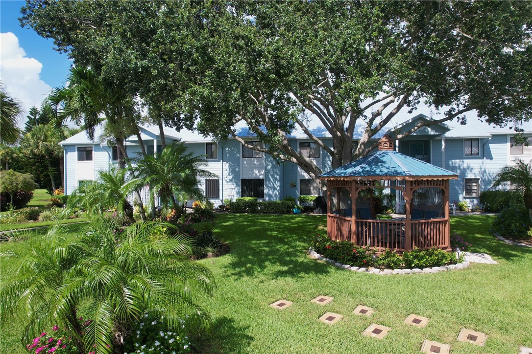 9635 Riverside Drive, Unit 4 Sebastian, FL 32958 - Photo 34 of 34 a front view of a house with a garden