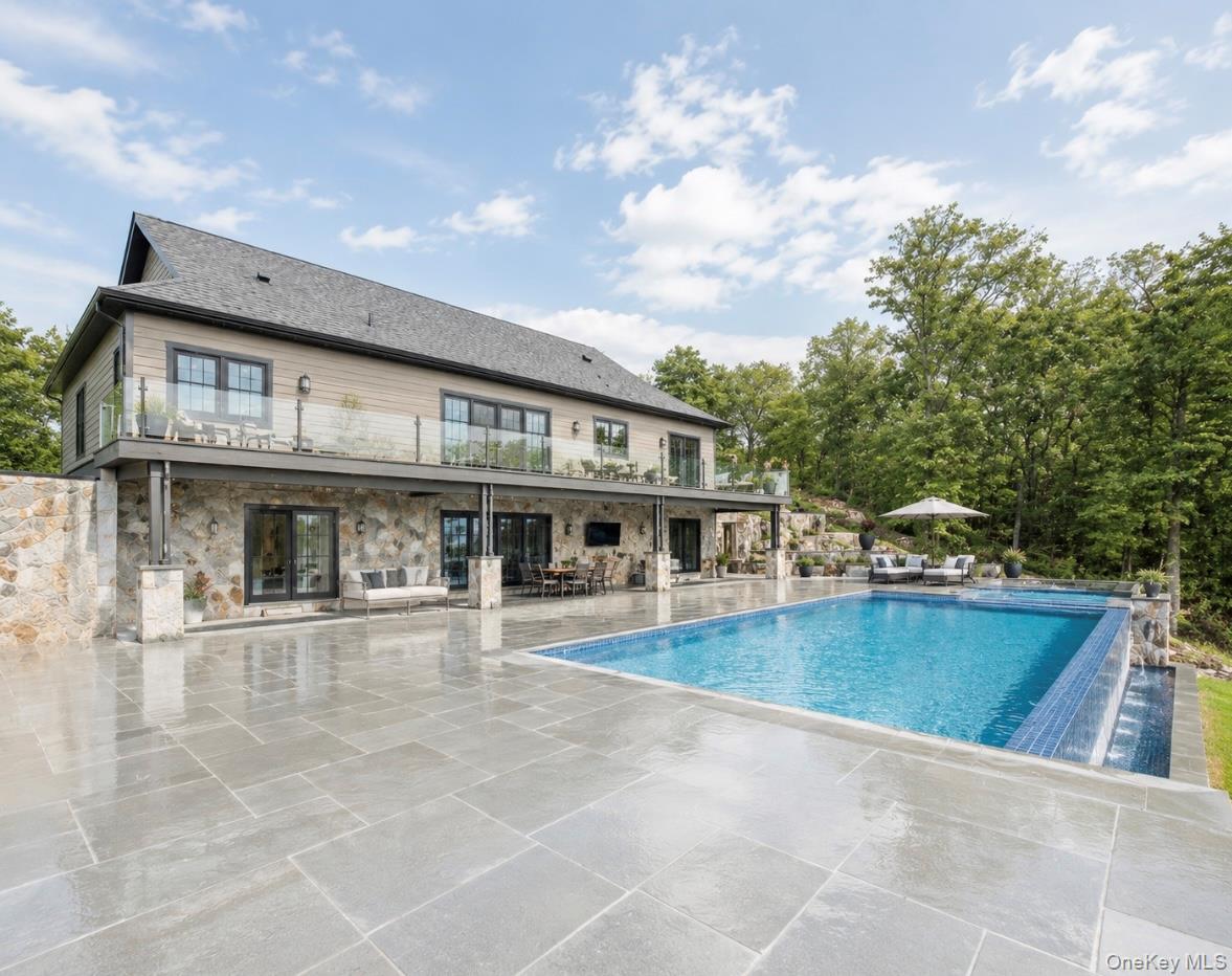 55 Ridgecrest Road Putnam Valley, NY 10537 - Photo 29 of 33 a view of a building with a swimming pool and sitting area