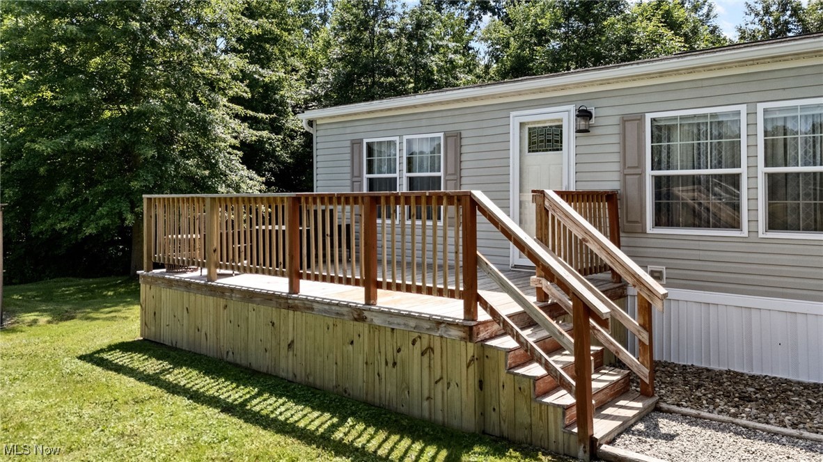 Wooden terrace featuring a lawn
