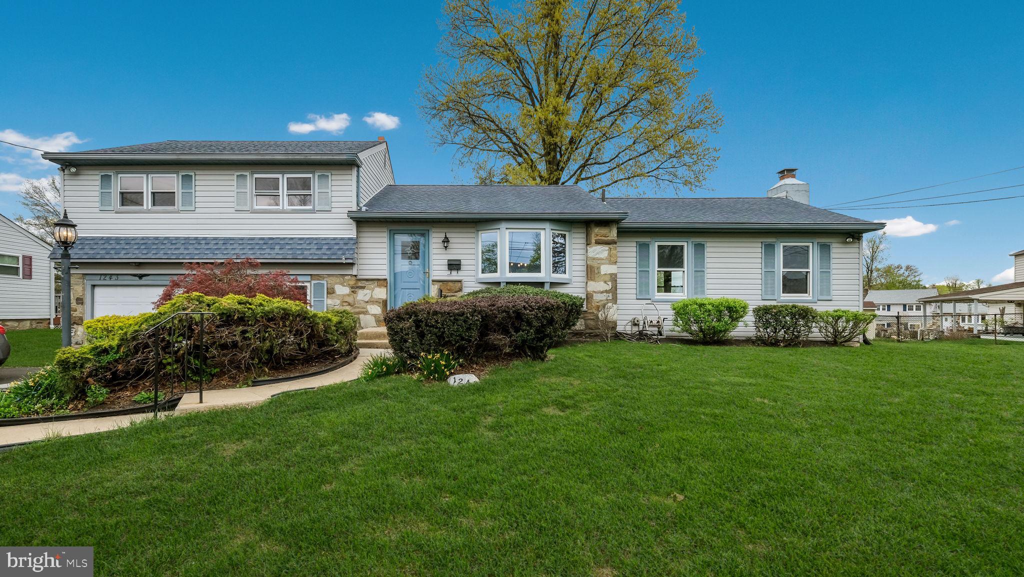 1243 Tulip Road Warminster, PA 18974 - Photo 1 of 33 a front view of a house with a yard