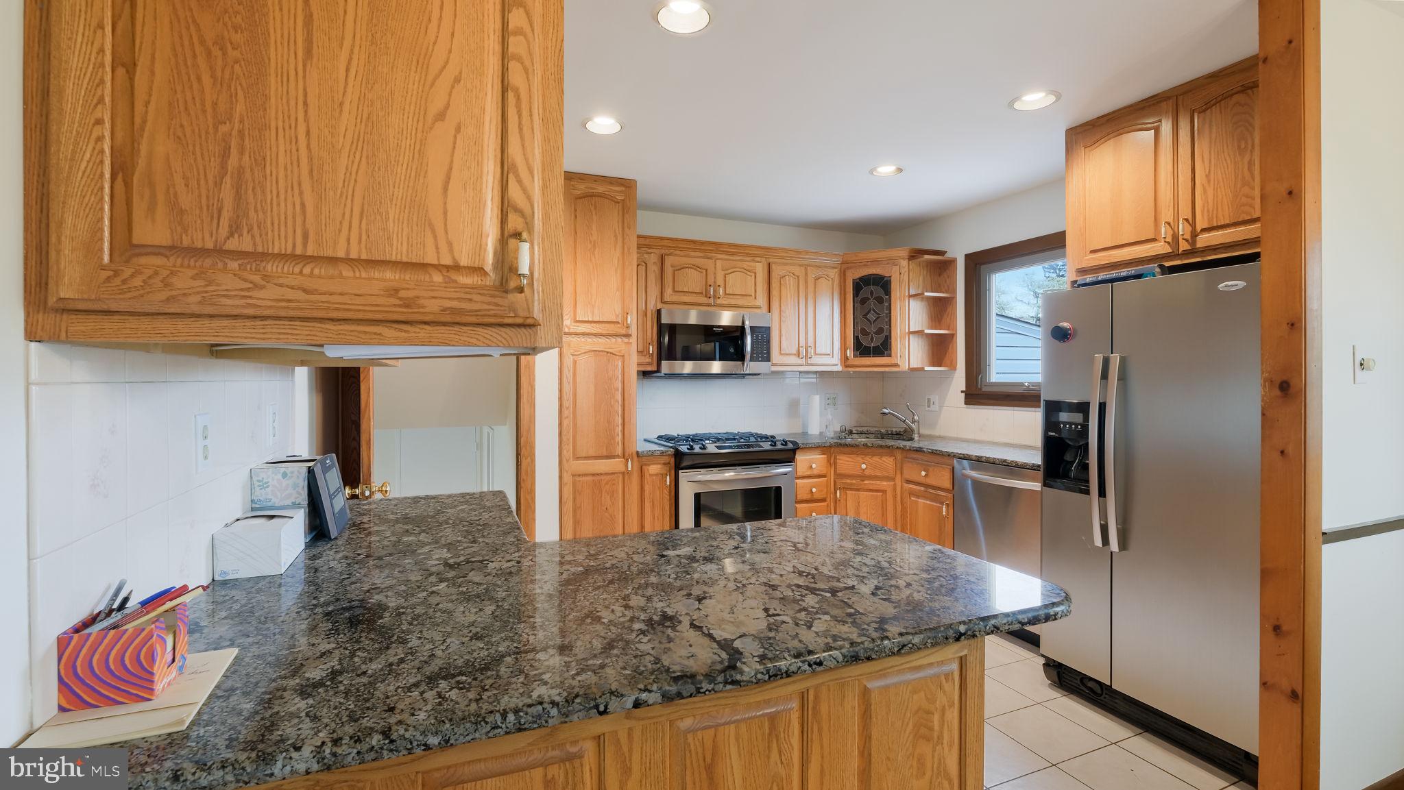 1243 Tulip Road Warminster, PA 18974 - Photo 12 of 33 a kitchen with stainless steel appliances granite countertop a refrigerator a stove top oven a sink and dishwasher