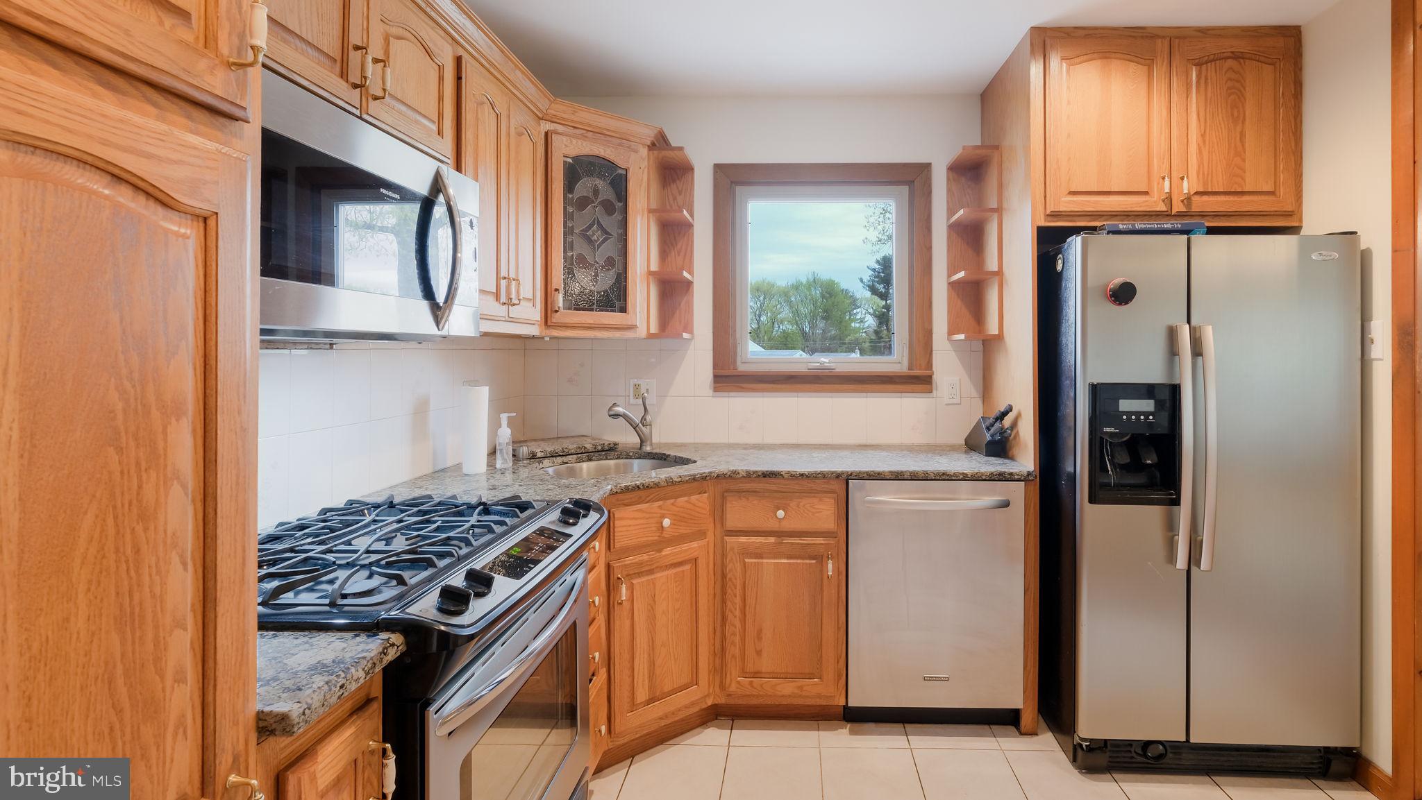 1243 Tulip Road Warminster, PA 18974 - Photo 14 of 33 a kitchen with stainless steel appliances granite countertop a refrigerator stove and a sink