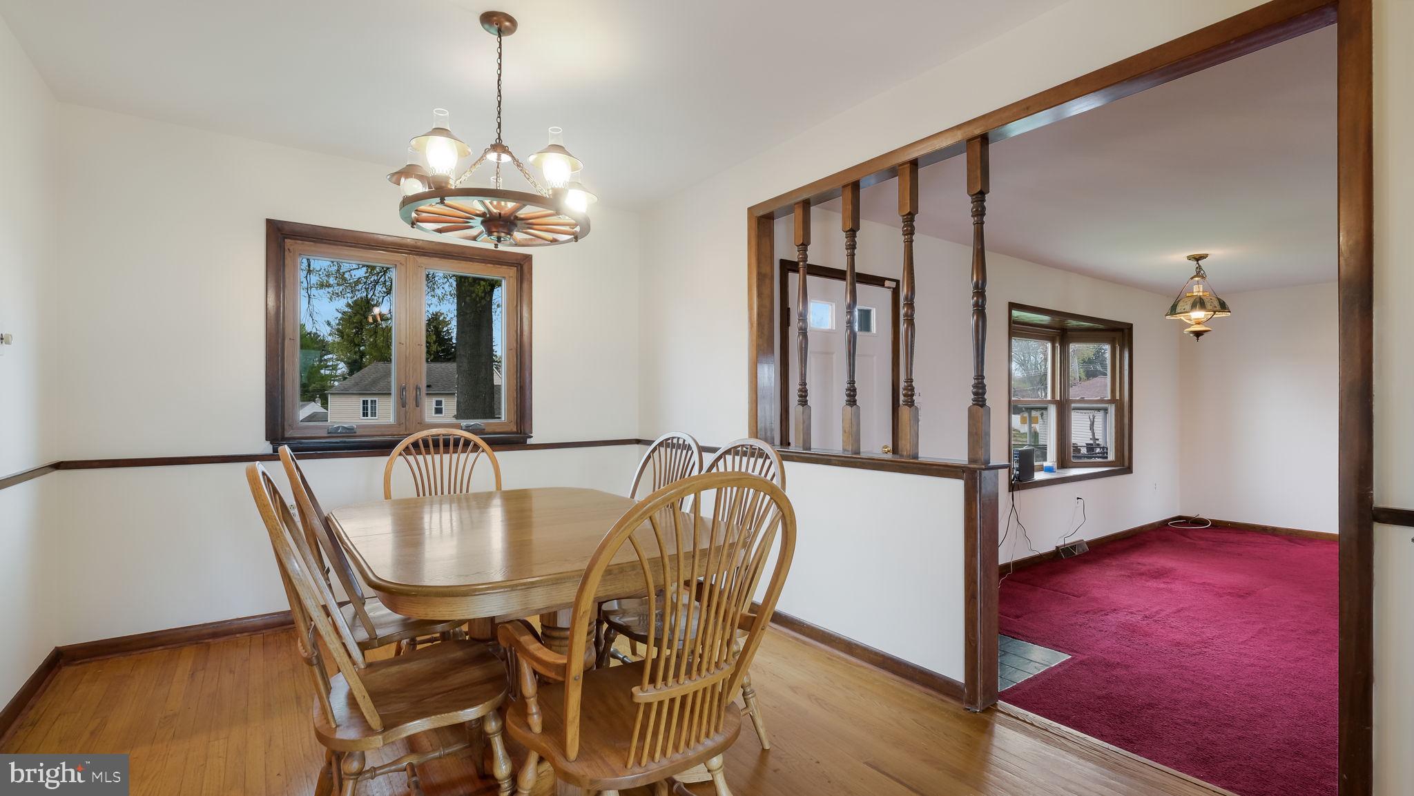 1243 Tulip Road Warminster, PA 18974 - Photo 16 of 33 a dining room with furniture a chandelier and wooden floor