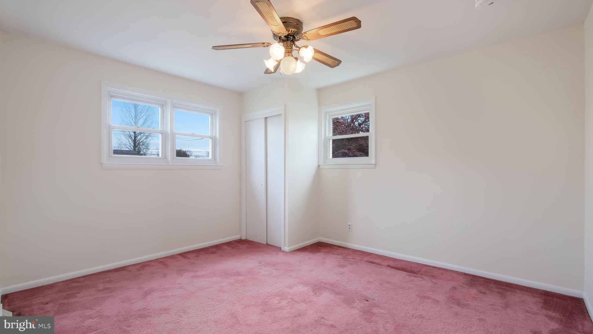 1243 Tulip Road Warminster, PA 18974 - Photo 23 of 33 an empty room with a chandelier fan and a window