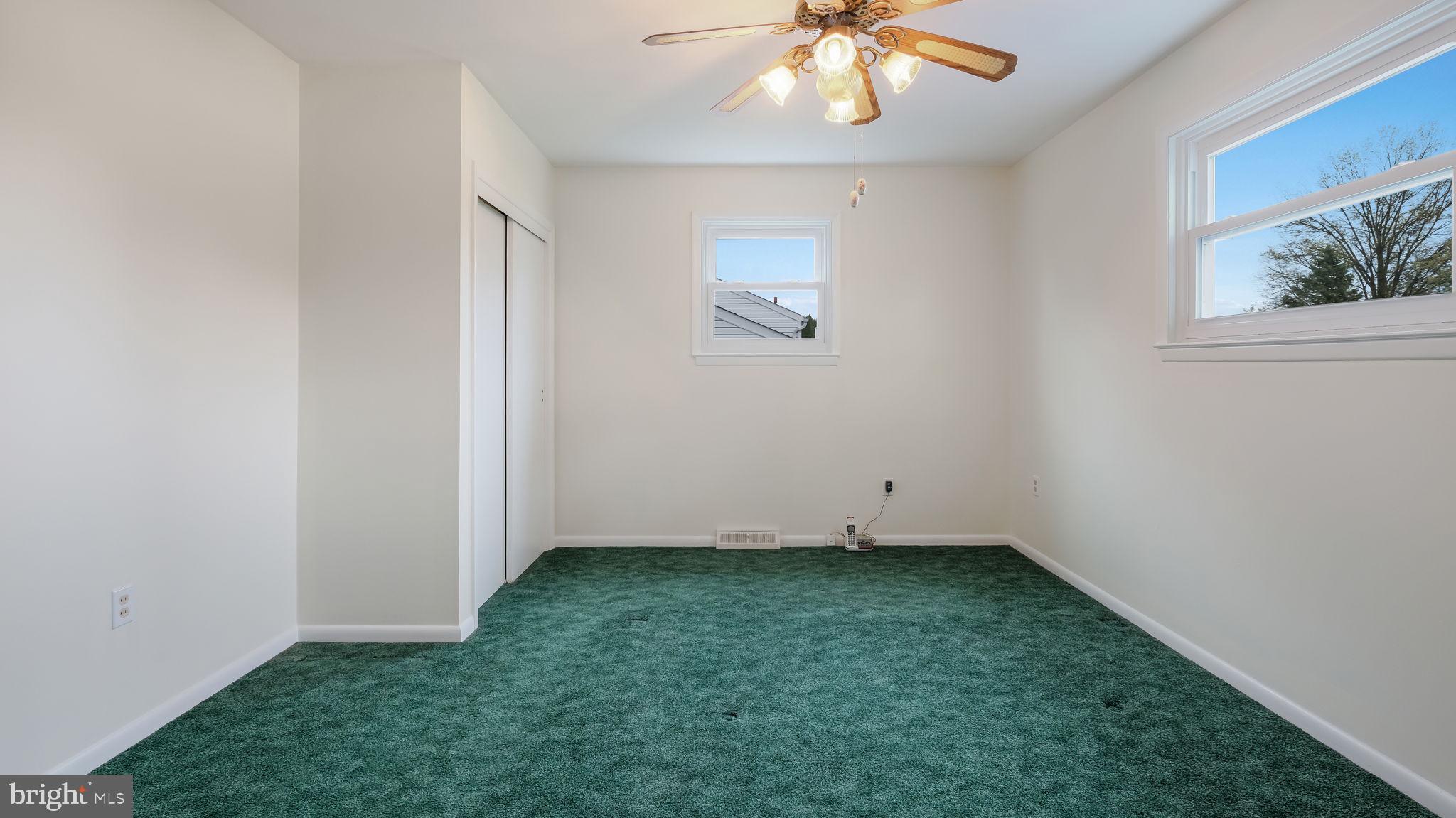 1243 Tulip Road Warminster, PA 18974 - Photo 24 of 33 an empty room with a chandelier fan
