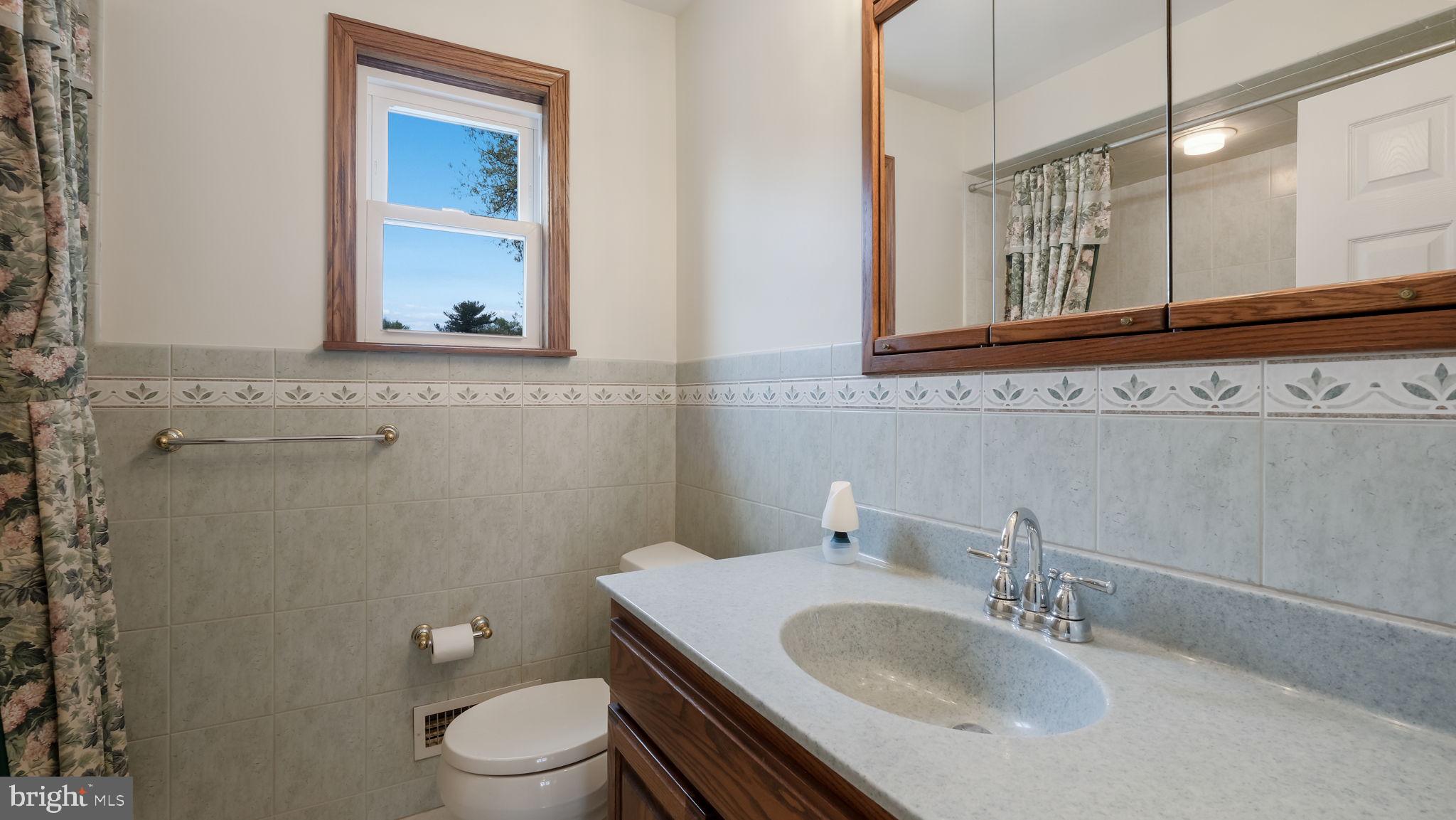 1243 Tulip Road Warminster, PA 18974 - Photo 25 of 33 a bathroom with a granite countertop toilet sink and mirror
