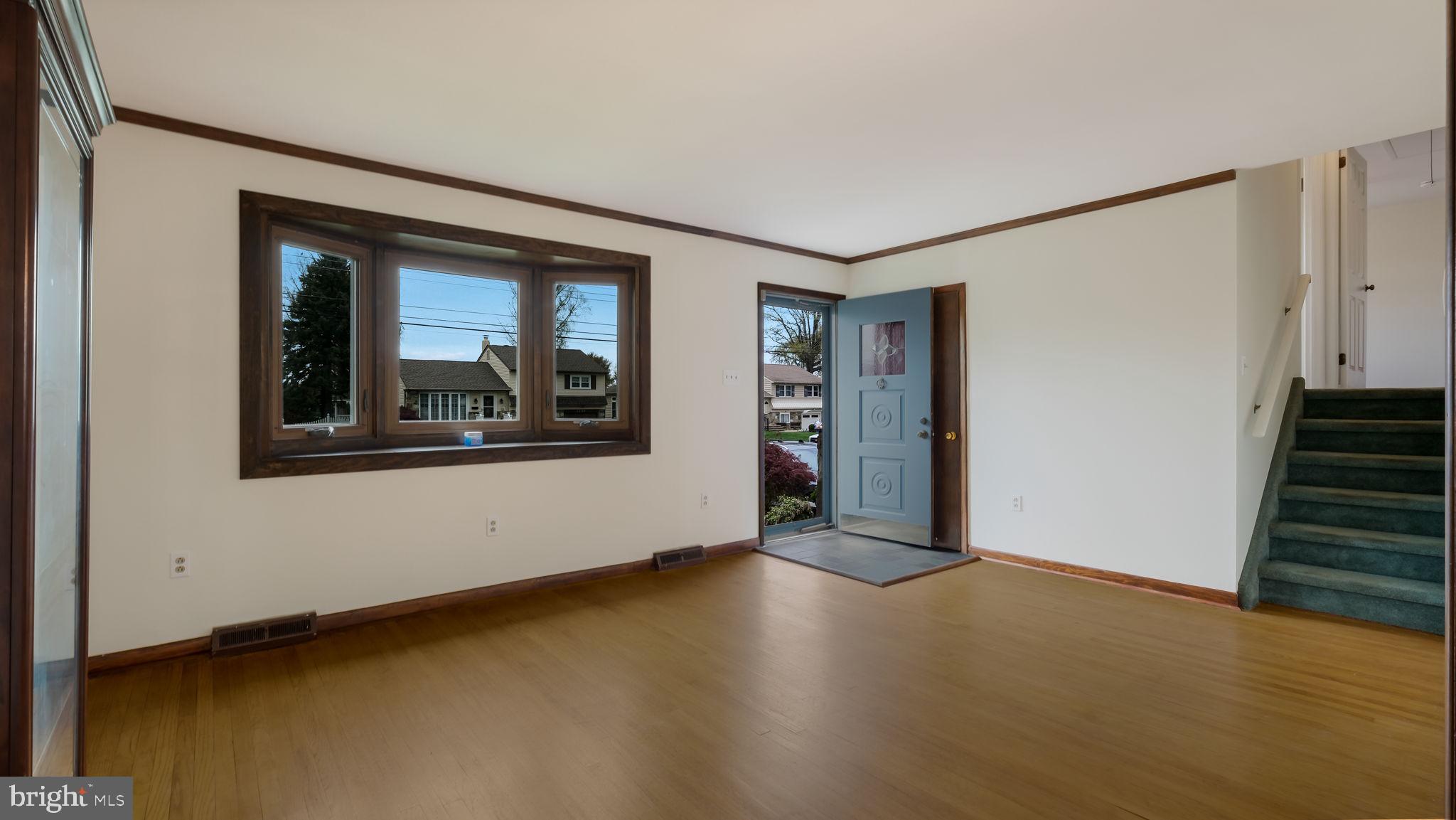 1243 Tulip Road Warminster, PA 18974 - Photo 6 of 33 a view of an empty room with wooden floor and a window