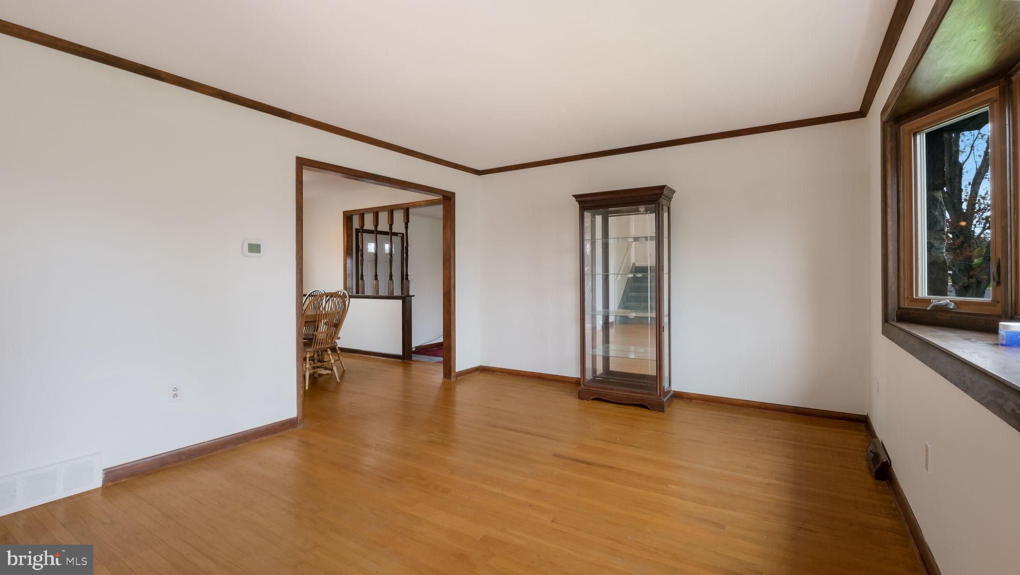 1243 Tulip Road Warminster, PA 18974 - Photo 7 of 33 an empty room with wooden floor and windows