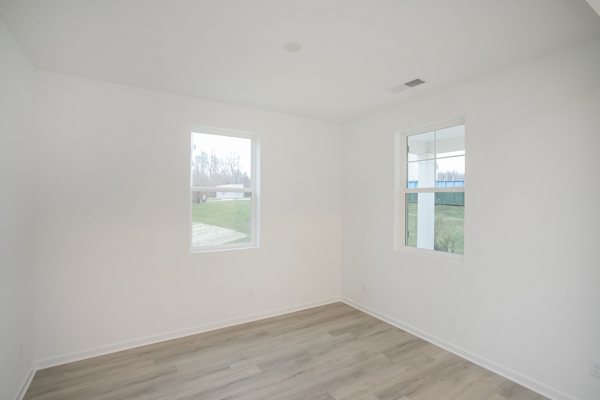 625 Maple Bend Dickson, TN 37055 - Photo 11 of 45 an empty room with wooden floor and windows