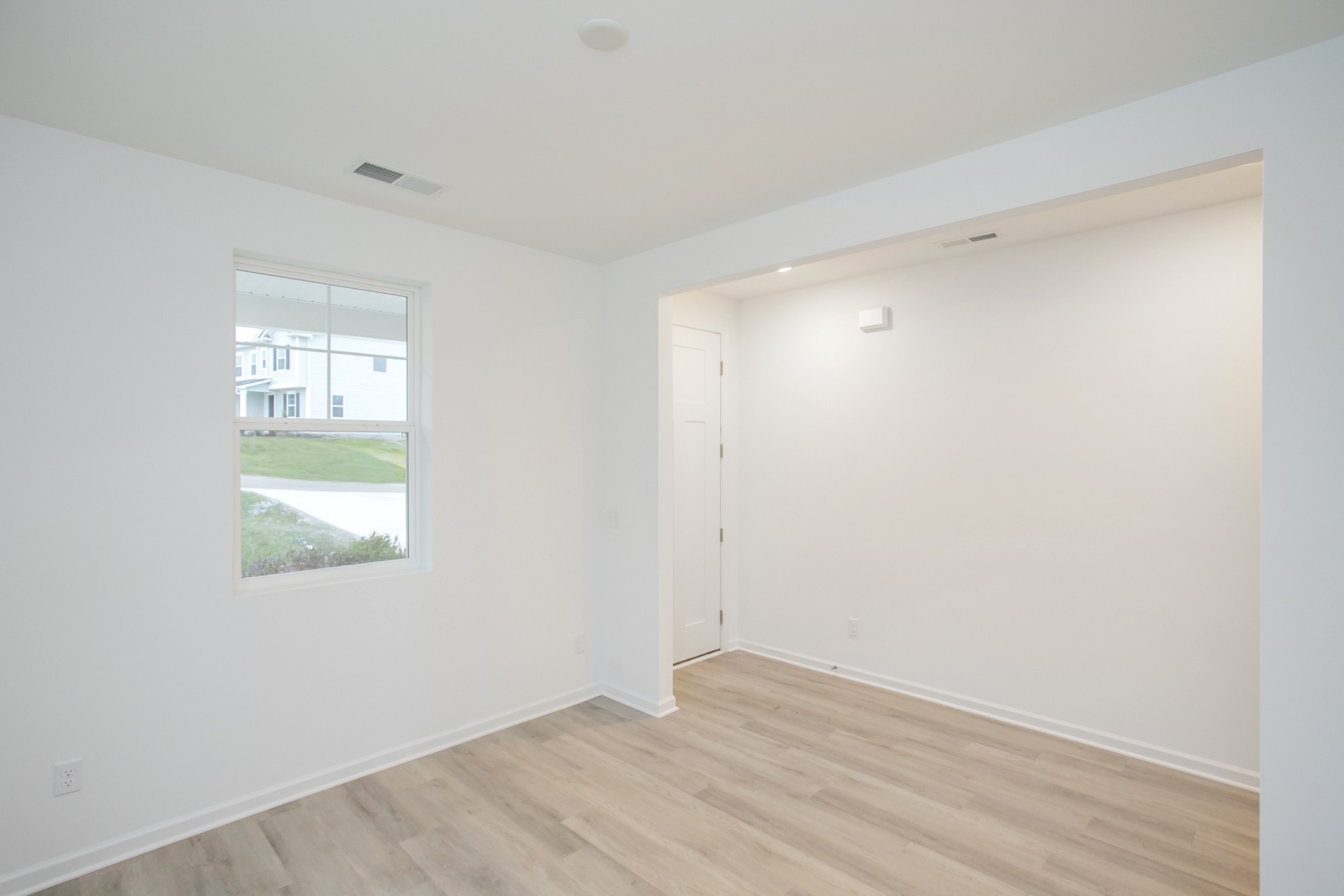 625 Maple Bend Dickson, TN 37055 - Photo 12 of 45 an empty room with wooden floor and windows