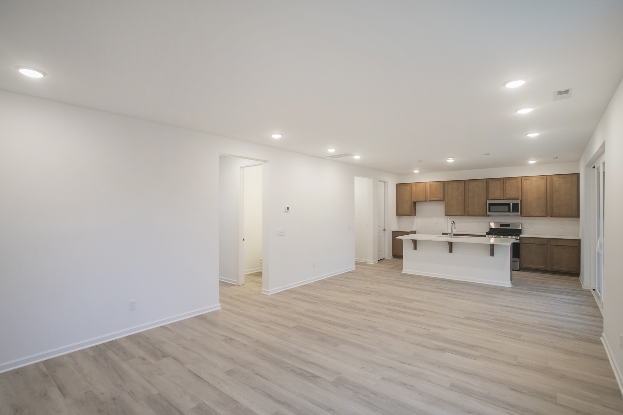 625 Maple Bend Dickson, TN 37055 - Photo 17 of 45 a view of a kitchen with kitchen island a sink dishwasher a stove and a refrigerator with wooden floor