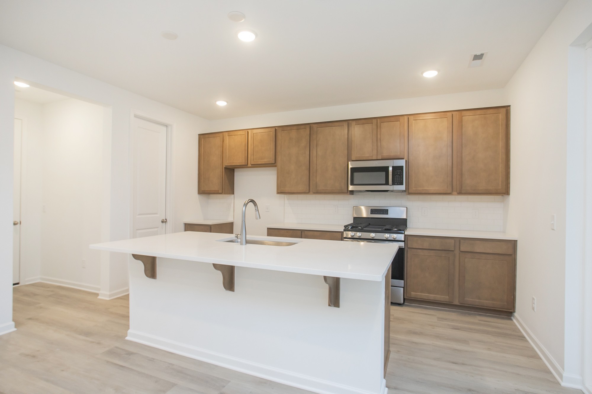 625 Maple Bend Dickson, TN 37055 - Photo 22 of 45 a kitchen with stainless steel appliances granite countertop a sink stove and microwave