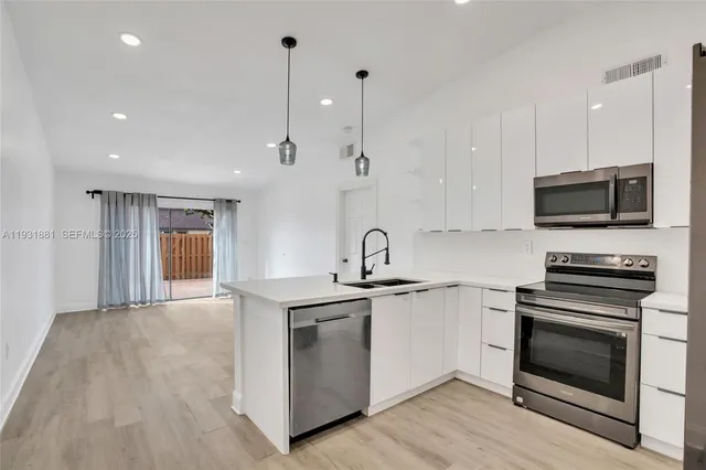 a kitchen with a sink stove and microwave