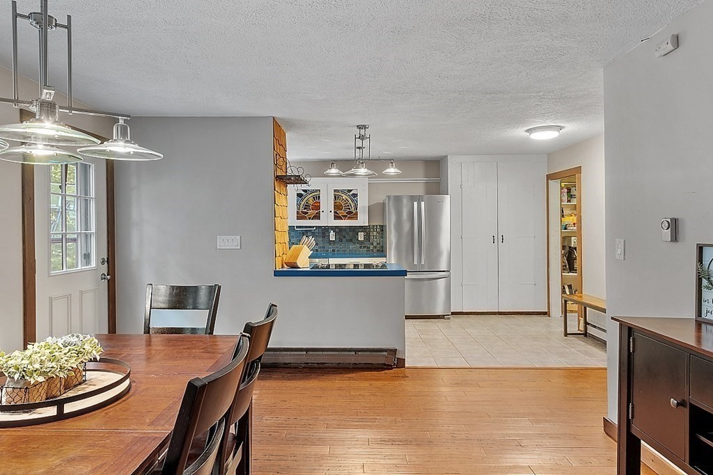 90 Minott Road Westminster, MA 01473 - Photo 12 of 41 a living room with kitchen island furniture and a chandelier