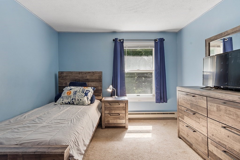 90 Minott Road Westminster, MA 01473 - Photo 26 of 41 a bedroom with a bed and a flat tv screen on dresser