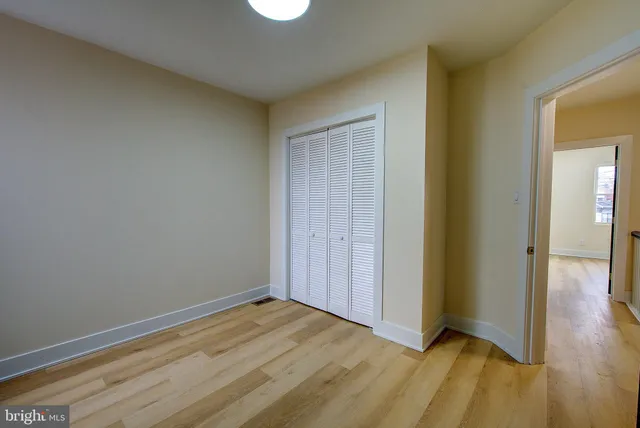 a view of an empty room and wooden floor