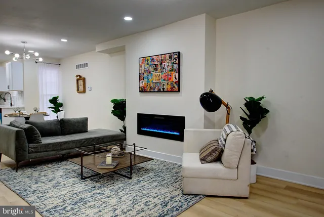 a living room with furniture and a fireplace