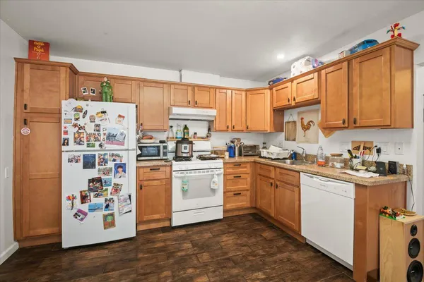 a kitchen with stainless steel appliances granite countertop a refrigerator sink and cabinets