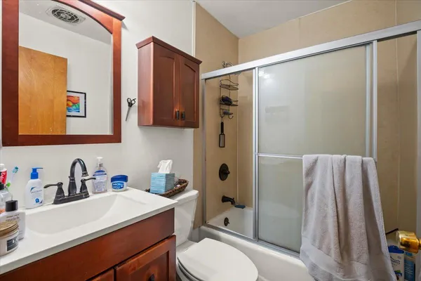 a bathroom with a sink toilet and shower