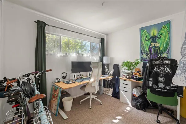 a view of a workspace with furniture and a window