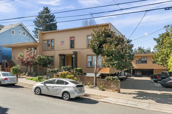 a view of a cars park in front of a house