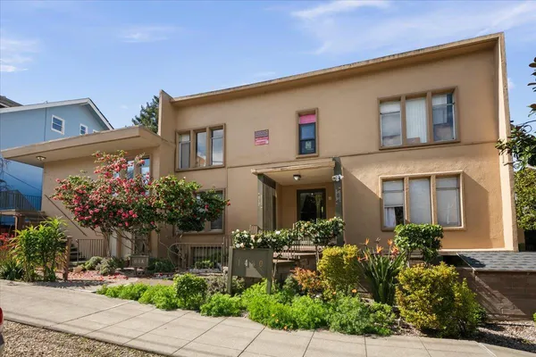 a front view of a house with plants