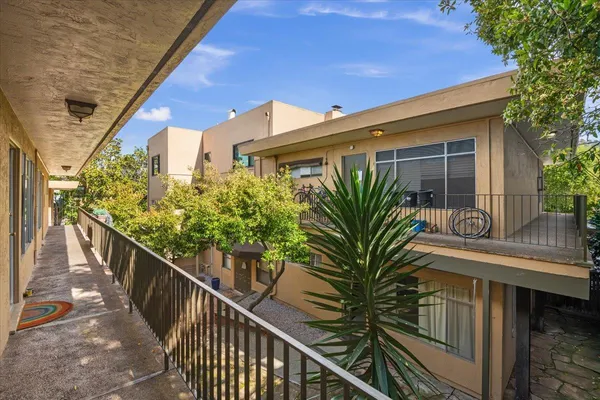 a view of a house with wooden stairs and a table