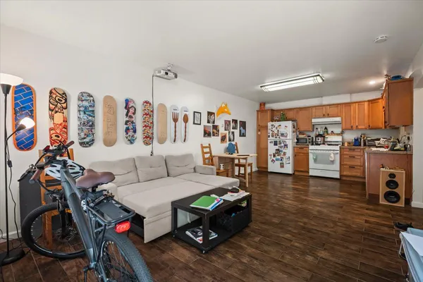 a living room with furniture a wooden floor and a sink