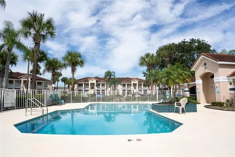 a swimming pool view with a outdoor seating