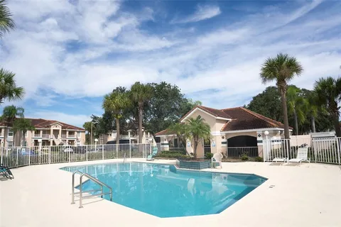 a view of a house with swimming pool and sitting area
