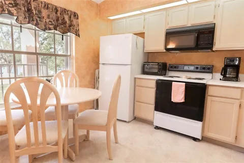a kitchen with stainless steel appliances a stove a sink and a refrigerator