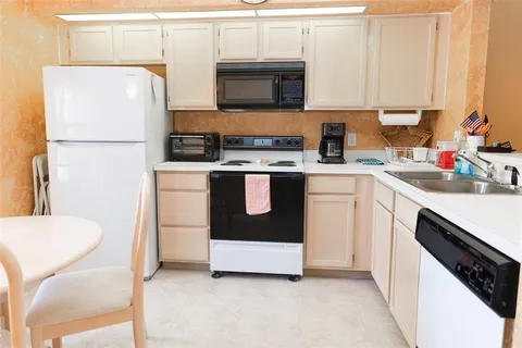 a kitchen with stainless steel appliances a stove a sink and a refrigerator