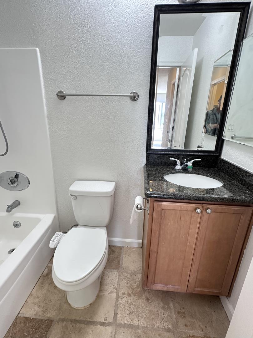 436 Dempsey Road, Unit 238 Milpitas, CA 95035 - Photo 6 of 16 a white toilet sitting next to a bathroom sink and a tub