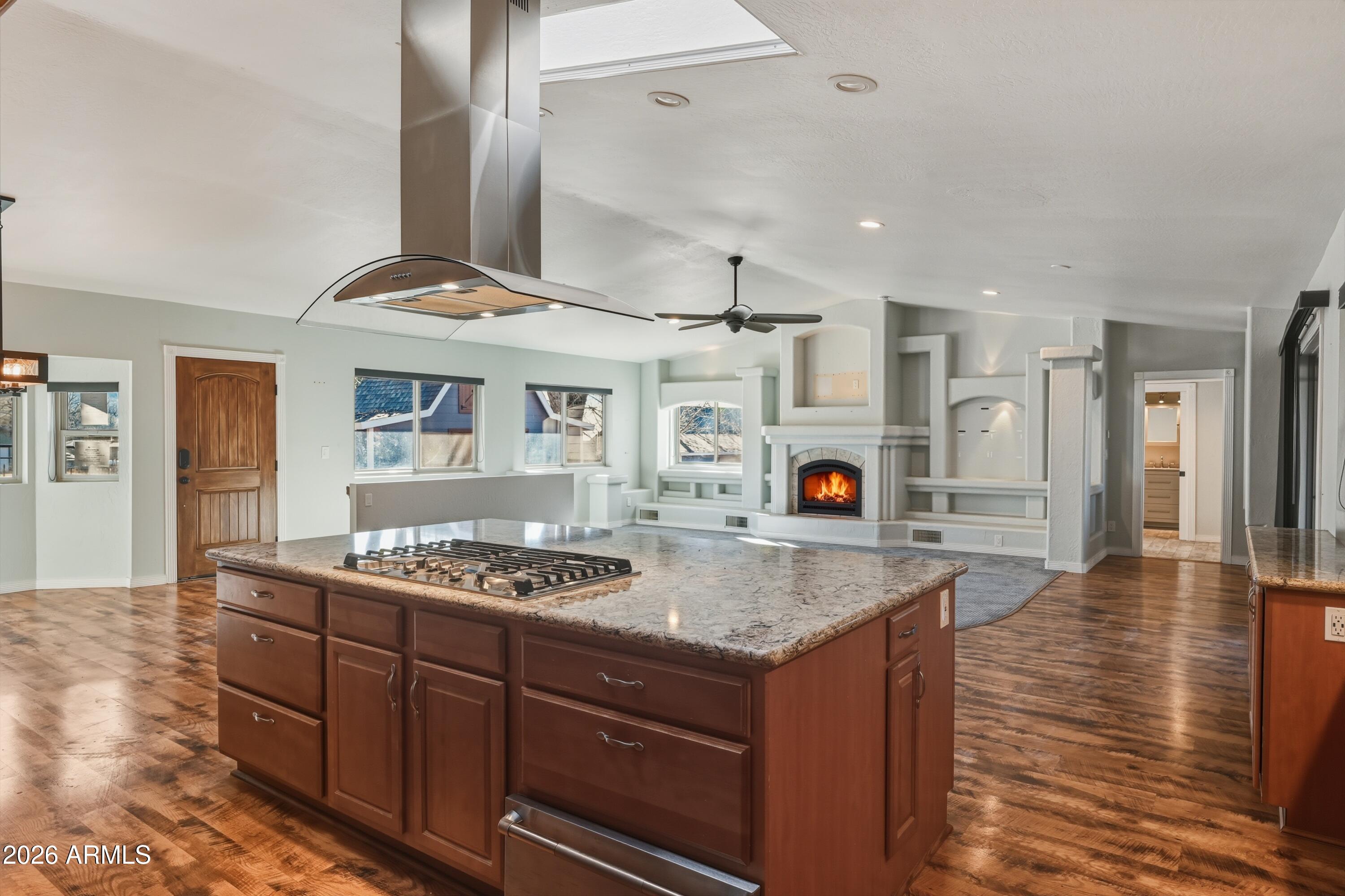 6475 Pine Cone Trail Pine, AZ 85544 - Photo 12 of 51 a kitchen with stainless steel appliances granite countertop a stove and a wooden floors