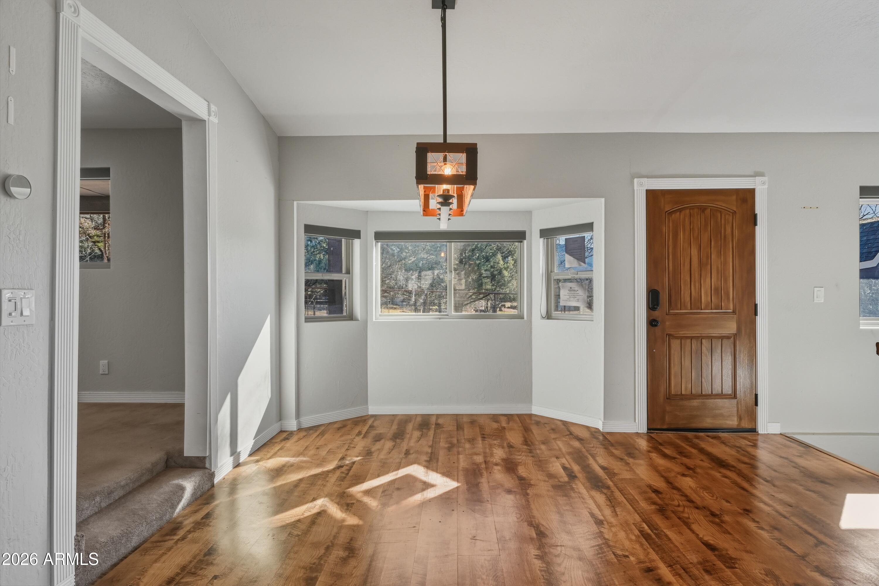6475 Pine Cone Trail Pine, AZ 85544 - Photo 15 of 51 a view of an empty room with wooden floor and a window