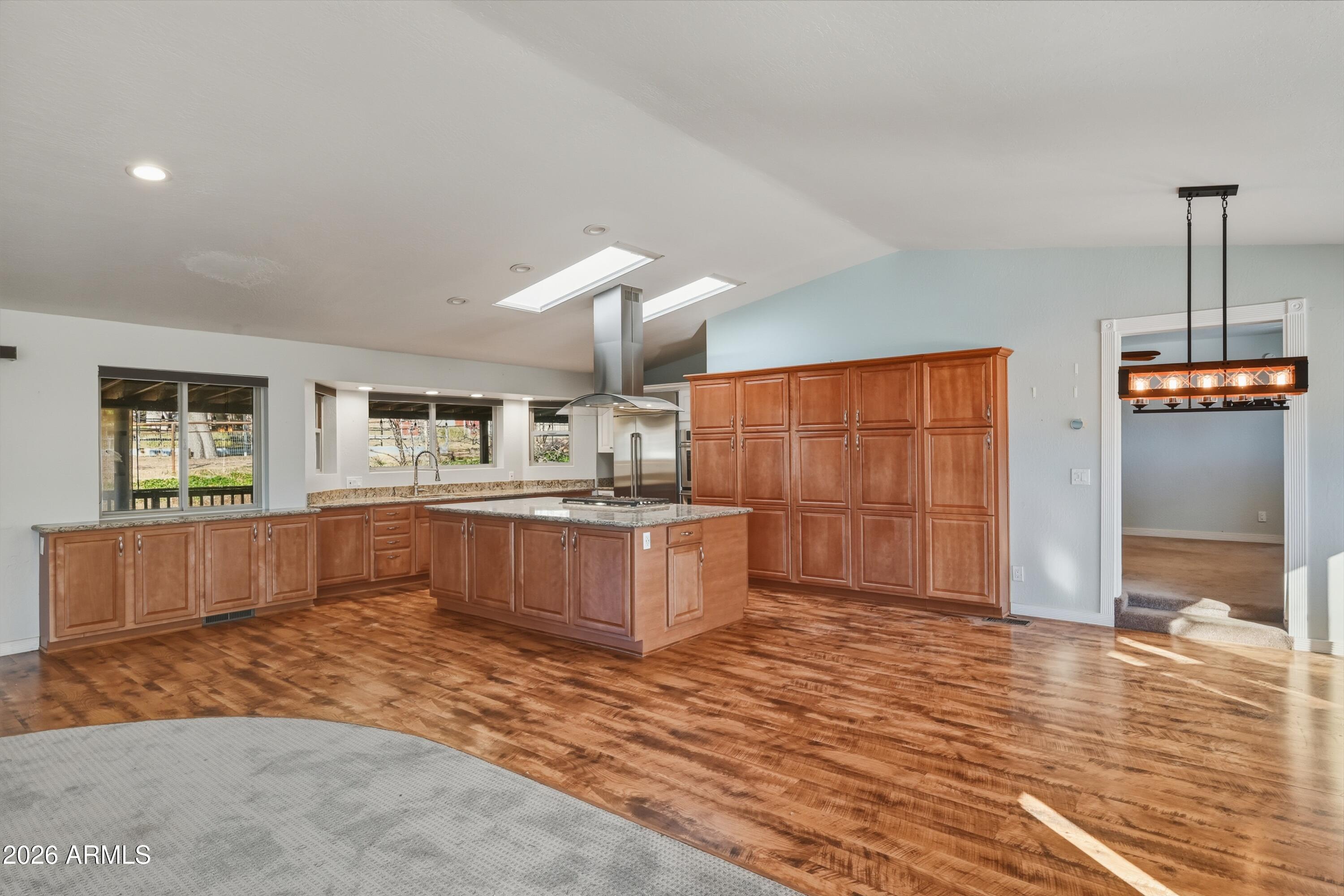 6475 Pine Cone Trail Pine, AZ 85544 - Photo 7 of 51 a kitchen with stainless steel appliances wooden cabinets a sink and a counter top space