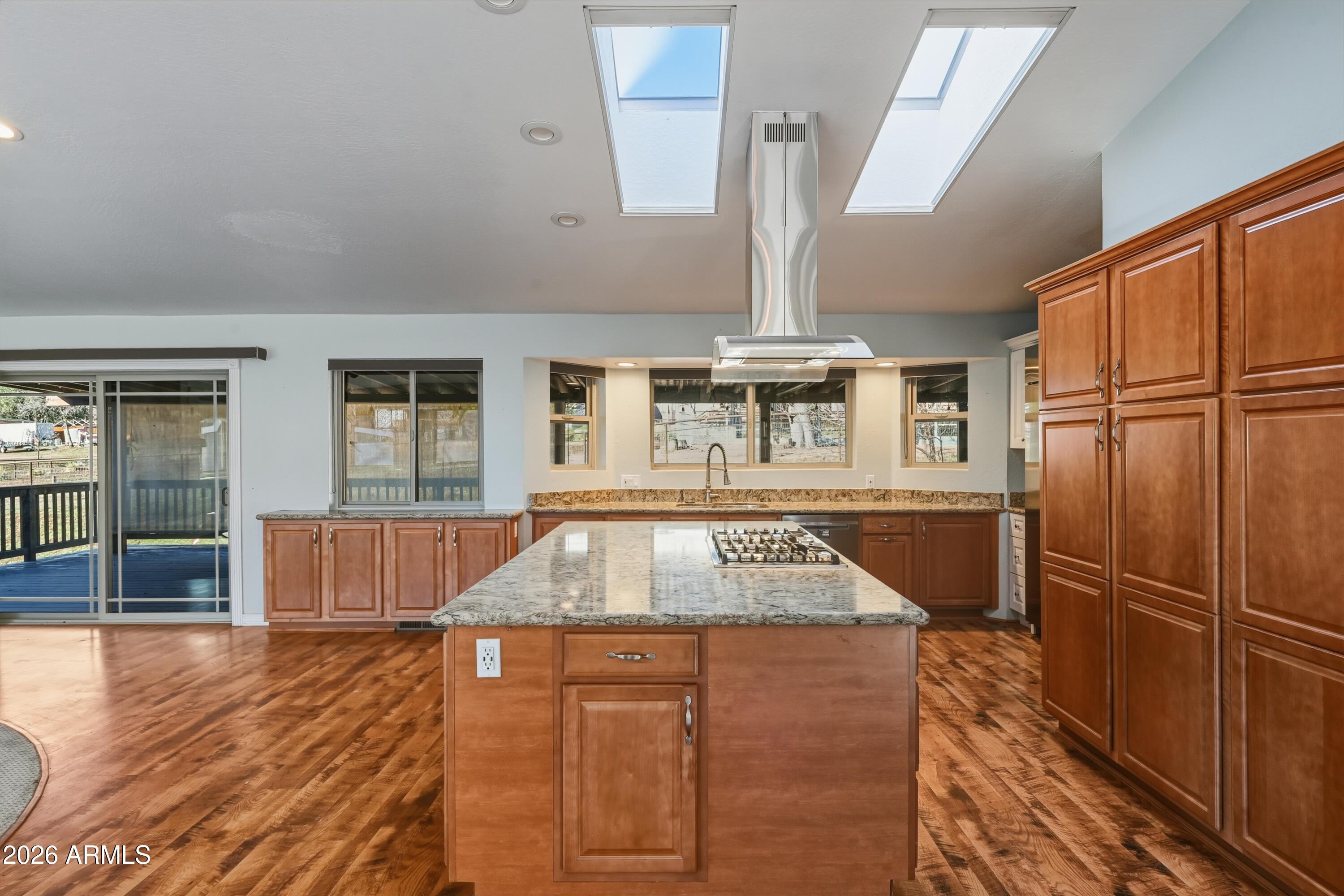 6475 Pine Cone Trail Pine, AZ 85544 - Photo 9 of 51 a kitchen with stainless steel appliances granite countertop a sink a stove and a wooden floors