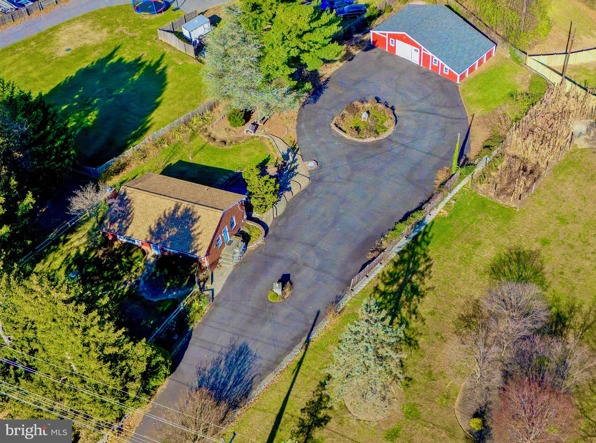 11914 Fingerboard Road Monrovia, MD 21770 - Photo 2 of 13 an aerial view of a house a yard and a swimming pool