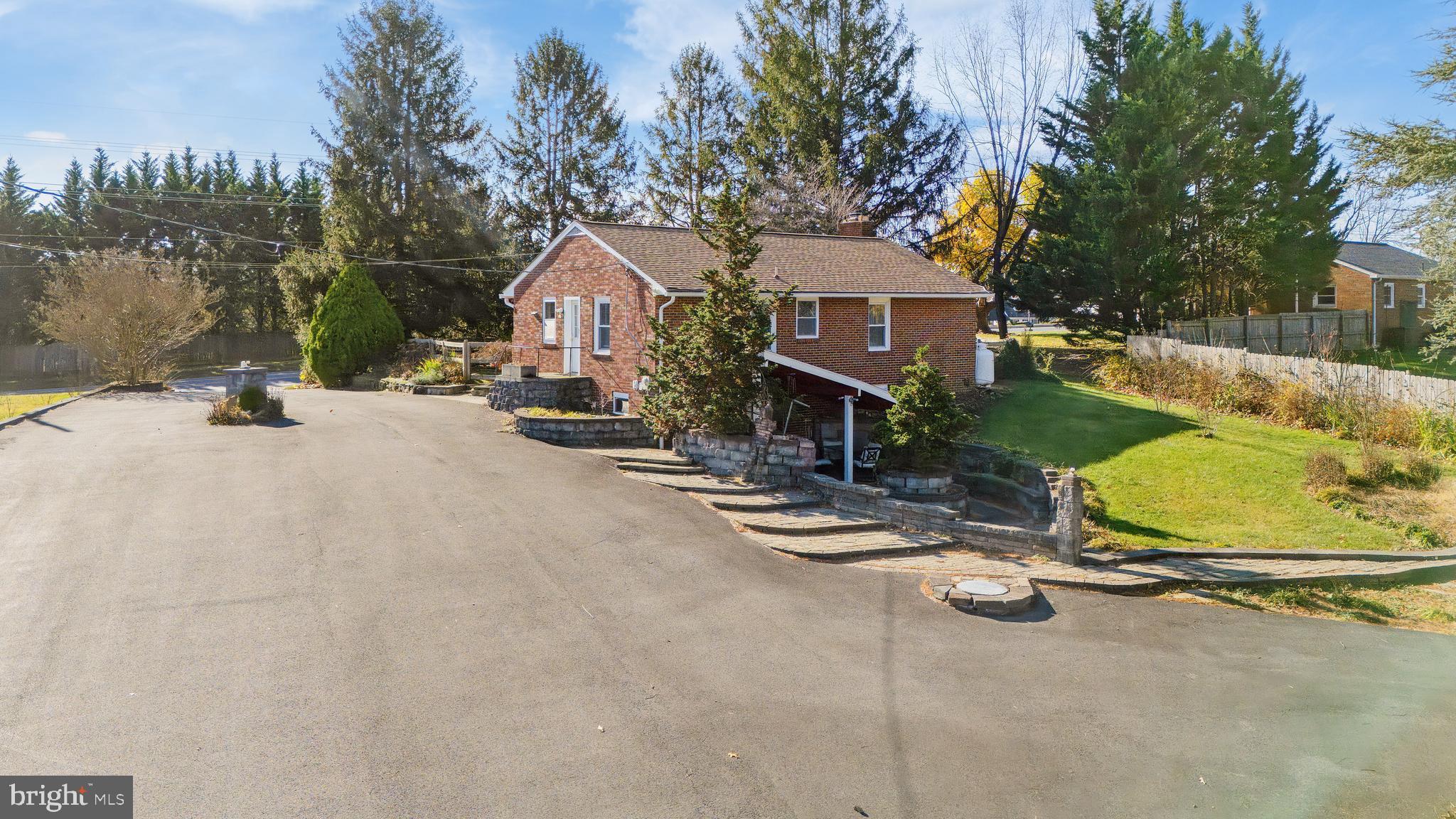 11914 Fingerboard Road Monrovia, MD 21770 - Photo 8 of 13 a view of a patio with a table and chairs under an umbrella
