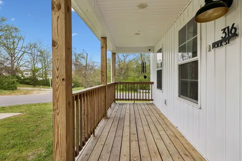 a view of balcony with floor to ceiling window wooden floor and outdoor space