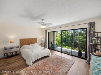 382 Golfview Road, Unit H North Palm Beach, FL 33408 - Photo 14 of 22 a bedroom with a large bed and a large window