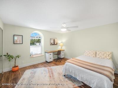 382 Golfview Road, Unit H North Palm Beach, FL 33408 - Photo 19 of 22 a bedroom with a bed and window
