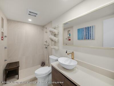 382 Golfview Road, Unit H North Palm Beach, FL 33408 - Photo 20 of 22 a bathroom with a granite countertop sink a toilet and a mirror
