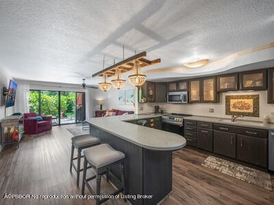 382 Golfview Road, Unit H North Palm Beach, FL 33408 - Photo 7 of 22 a large kitchen with a table and chairs in it