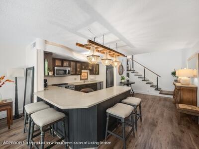 382 Golfview Road, Unit H North Palm Beach, FL 33408 - Photo 8 of 22 a view of a dining room with furniture and wooden floor