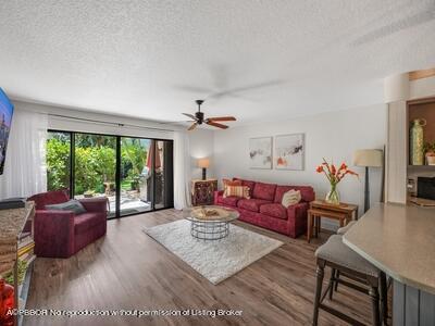 382 Golfview Road, Unit H North Palm Beach, FL 33408 - Photo 10 of 22 a living room with furniture fireplace and a large window
