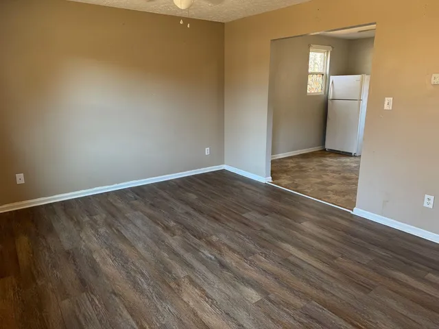 a bathroom with a granite countertop toilet and a shower