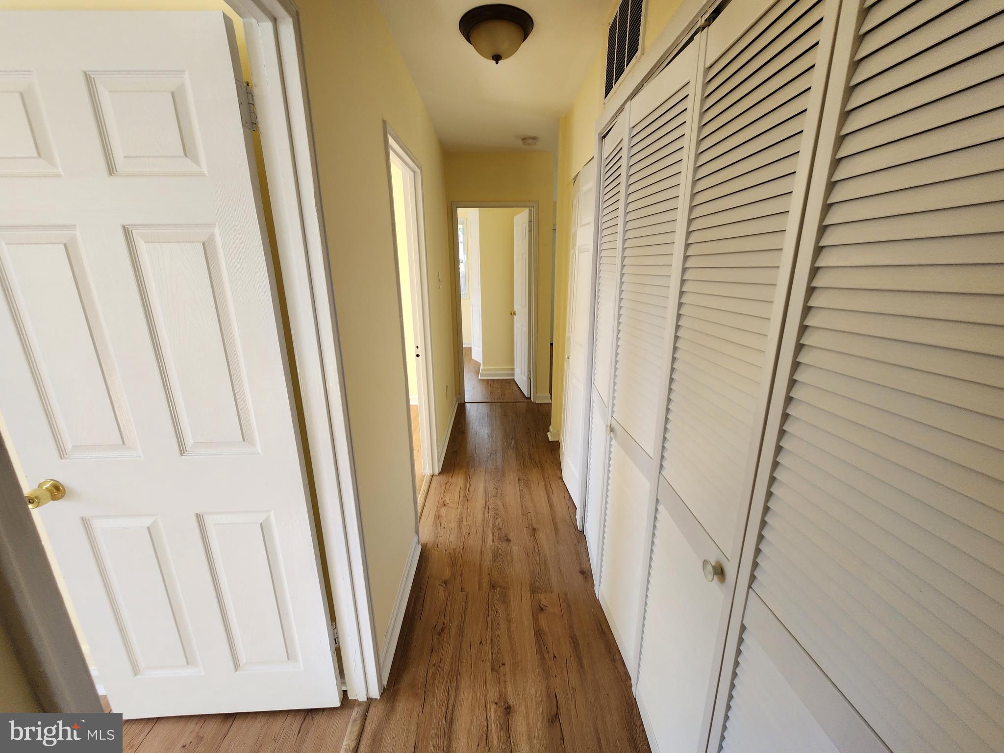 7533 Greenleaf Road Landover, MD 20785 - Photo 16 of 36 a view of a hallway with wooden floor and staircase